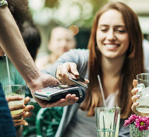 Person tapping their phone to pay.