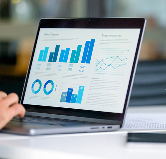 Laptop with financial graphs.