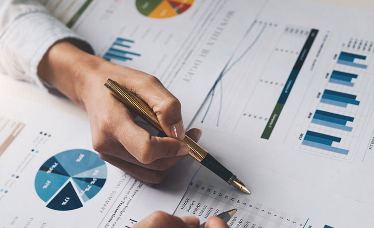 Pen and financial graphs.