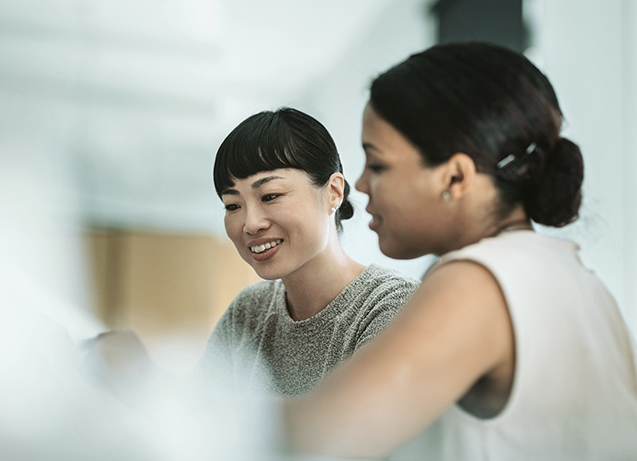 Two women looking at a career portal.
