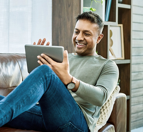 Person on couch with tablet.
