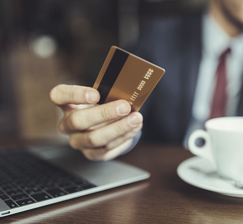 Person presenting a credit card.