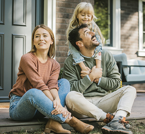 Family sitting on a front porch.
